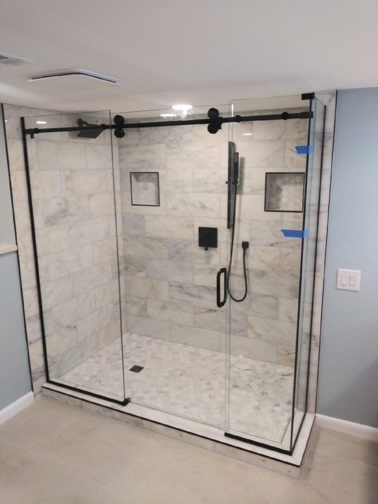 Sliding shower door with brushed nickel hardware