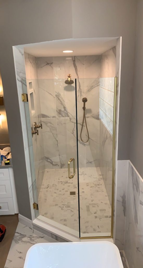Custom hinged shower door with brushed nickel hardware